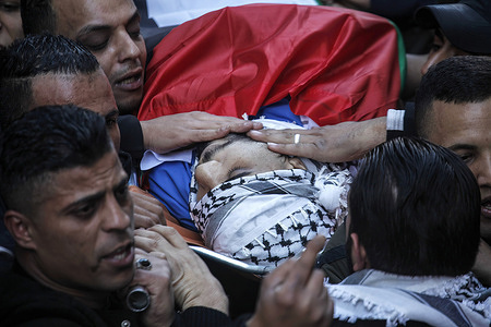 (EDITORS NOTE: Image depicts death)Palestinian mourners carry the body of 21-year-old Bakr Hashash at the Balata refugee camp in the West Bank. The Israeli army said its forces shot a gunman who shot soldiers during an operation to arrest a wanted suspect in Nablus.