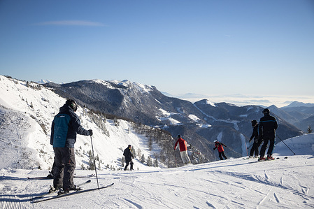 Skiers descend on a ski slope at the Soriska planina AlpVenture ski resort in Slovenia.