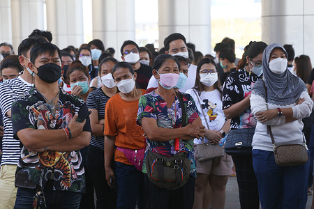 People wearing facemasks as a preventive measure against the spread of Covid-19 line up to receive coronavirus (Covid-19)vaccine booster shots at Central Vaccination Center Bangkok.