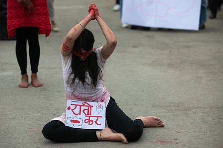 A youth seen covered in blood color with a placard expressing her opinion during the demonstration.
Hundreds of youths participated in the protest as they demanded Nepal government to make sanitary pads, tax free, because their prices had increased.