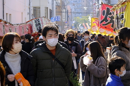 People wearing face masks as a preventive measure against the spread of covid-19 walk along Shinjuku street in Tokyo.
The Tokyo metropolitan government on Monday reported 871 new coronavirus cases, down 352 from Sunday and 768 more than last Monday.