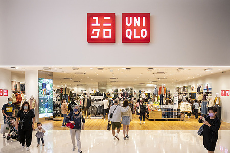 Shoppers are seen at the Japanese clothing brand Uniqlo store in Hong Kong.