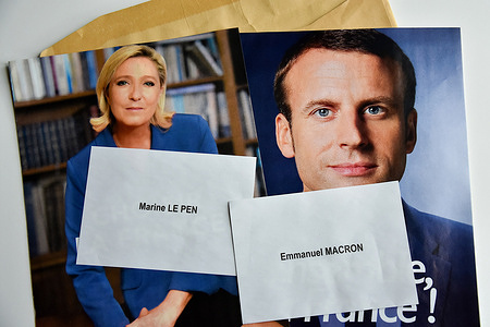 In this photo illustration, the ballot papers and election posters of Marine Le Pen and Emmanuel Macron are seen displayed on a table.
Despite not officially being a candidate for re-election, the President of the French Republic, Emmanuel Macron is leading the polls for the presidential elections of 2022 with 27% of the voting intentions, putting him ahead of Marine Le Pen of the Rassemblement National (RN or National Rally) party, who polled only 17.5%. The first round of France's Presidential election will take place on April 10, 2022.