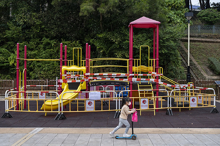 A kid rides on an electric scooter past a closed playground in Hong Kong.
Hong Kong government reintroduced stricter Covid social restrictions forcing businesses and public places to close for at least after the Chinese New Year (CNY) holiday and festivities to control the spread of the Omicron variant as the government's strategy continues to aim for zero infections in the city.