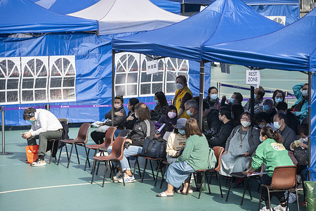 Residents wait at a rest area after receiving a Pfizer/BioNTech COVID-19 vaccine at a mobile vaccination station temporarily set-up for elderly residents and walk-in service in Hong Kong. 
As at January 15th 2022, 70% of Hong Kong eligible population has received the 2nd vaccine and, with the third dose, only just over 7.5%.