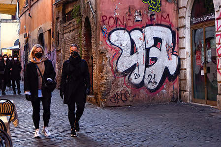 Women seen walking in the Trastevere district.The Lazio Region has the highest number of Covid-19 infections, whose peak is expected to stop by the end of January.