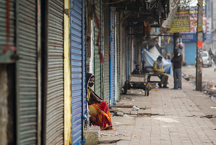 A woman wearing a face mask peeps through closed shutters of shops at Sadar bazaar.
Due to the rising Covid-19 cases in Delhi, the government has imposed weekend curfew. Delhi Health Minister Satyendar Jain said that the weekend curfew and preemptive restrictions helped in curbing the spread of Covid-19 in the national capital. Delhi reported 20,718 covid cases and 30 death on 16th January 2022, while the positivity rate stood at 30.64 per cent.