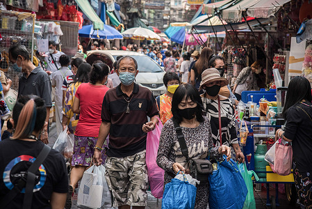 People wearing face masks as a preventive measure against the spread of covid-19 seen walking through Sam Peng market in Bangkok.