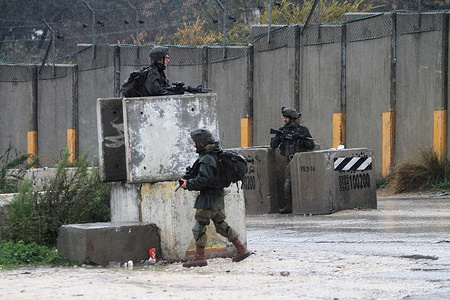 Israeli soldiers guard after they closed the gate of the Jewish settlement of Shavei Shomron in the West Bank near the city of Nablus in front of Palestinians and Jewish settlers in anticipation of clashes at the site of the settlement of Homesh, which was evacuated in 2007.