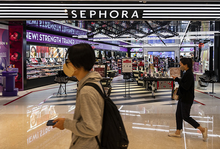 Shoppers walk past the French multinational personal care and beauty retail brand Sephora store in Hong Kong.