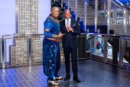 New York City Mayor Eric Adams (D) stands with Michael James Scott (plays the role of Genie in Aladdin) at the Empire State Building at the launch of NYC & Company’s NYC Winter Outing Program.