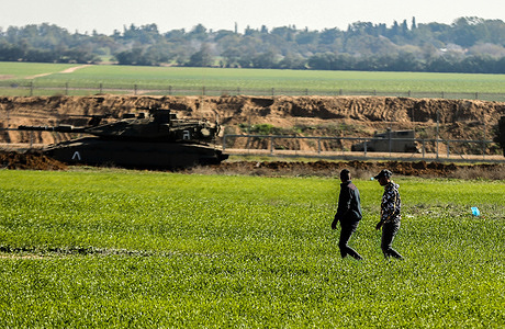 Farmers work on a farm near the border separating Gaza and Israel.
An Israeli army bulldozer was razing some parts of the Palestinian agricultural land in ​Khuza'a, east of Khan Yunis, in the southern Gaza Strip.