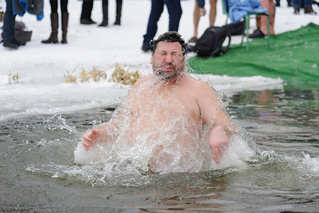 A man takes a bath in cold water during the celebration of Epiphany.
People believe that water has special healing properties and can be used to treat various diseases, and many of them take ice baths as part of its celebration.