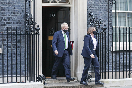 UK Prime Minister, Boris Johnson leaves his office at 10 Downing Street to attend the weekly Prime Minister Questions, during which he is expected to deliver an update regarding the lift of COVID related restrictions on the nation.