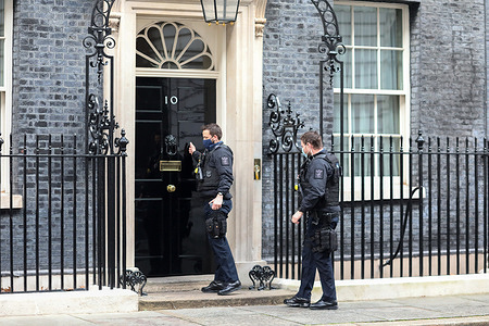 Members of the British Police seen entering No. 10 Downing Street.