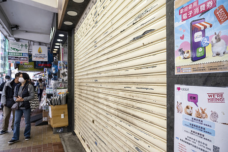 Pedestrians walk past a closed pet shop which sells hamsters in Hong Kong. 
After a pet shop employee contracted Covid-19, authorities plan a cull of over 2,000 hamsters after finding evidence of possible animal-to-human transmission of Covid-19.
