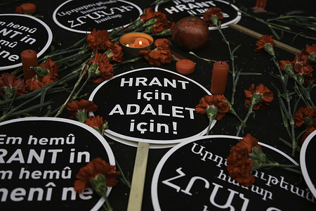 Placards saying "For Hrant, For Justice" seen next to burning candles and flowers during the commemoration.People gathered at the place where Turkish-Armenian journalist Hrant Dink was killed on the 15th anniversary of his murder.