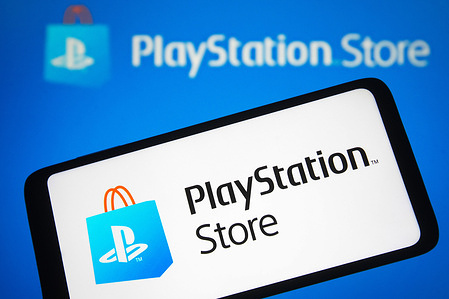 In this photo illustration, a PlayStation Store (PS Store) logo is seen on a smartphone and a computer screen.