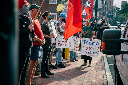 Protesters hold placards and flags expressing their opinions during the demonstration.
Protesters gathered outside Mathew’s, Portland’s oldest pub, where it had been reported the Neo-Nazi group the Proud Boys would be meeting in a back room. The rally was attended by Antifa supporters and left-leaning locals alike, standing with signs and flags in silent protest.