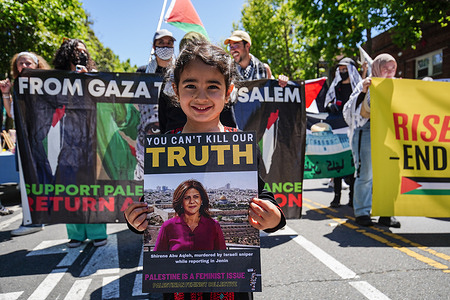 A girl holds a photo of Al Jazeera reporter Shireen Abu Akleh during the rally. Hundreds of people participated in the "Rise up for Palestine" rally in San Francisco after Al Jazeera reporter Shireen Abu Akleh was shot dead on May 11, 2022 as she was covering the storming of Jenin refugee camp in the West Bank.